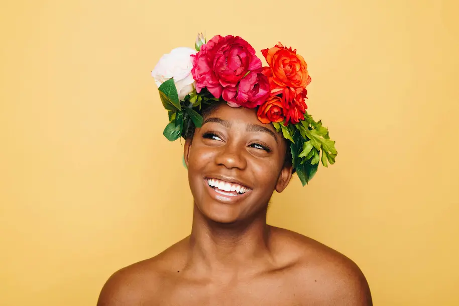 young person with healthy skin and flowery head piece